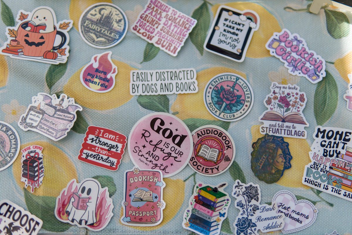 Spread of book-themed vinyl stickers on a lemon tablecloth